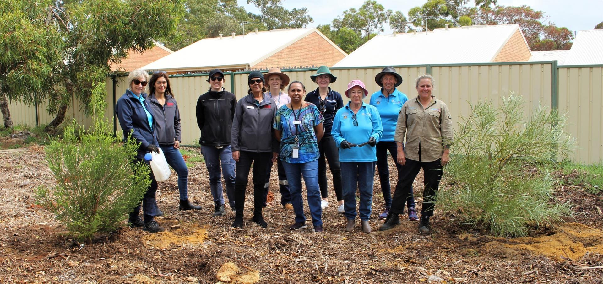 Staff from the Department of Communities, Centacare, the City of Greater Geraldton along with Community Nursery Volunteers among the trees and seedlings they planted at the newly created open space on Bogle Way in Spalding.
