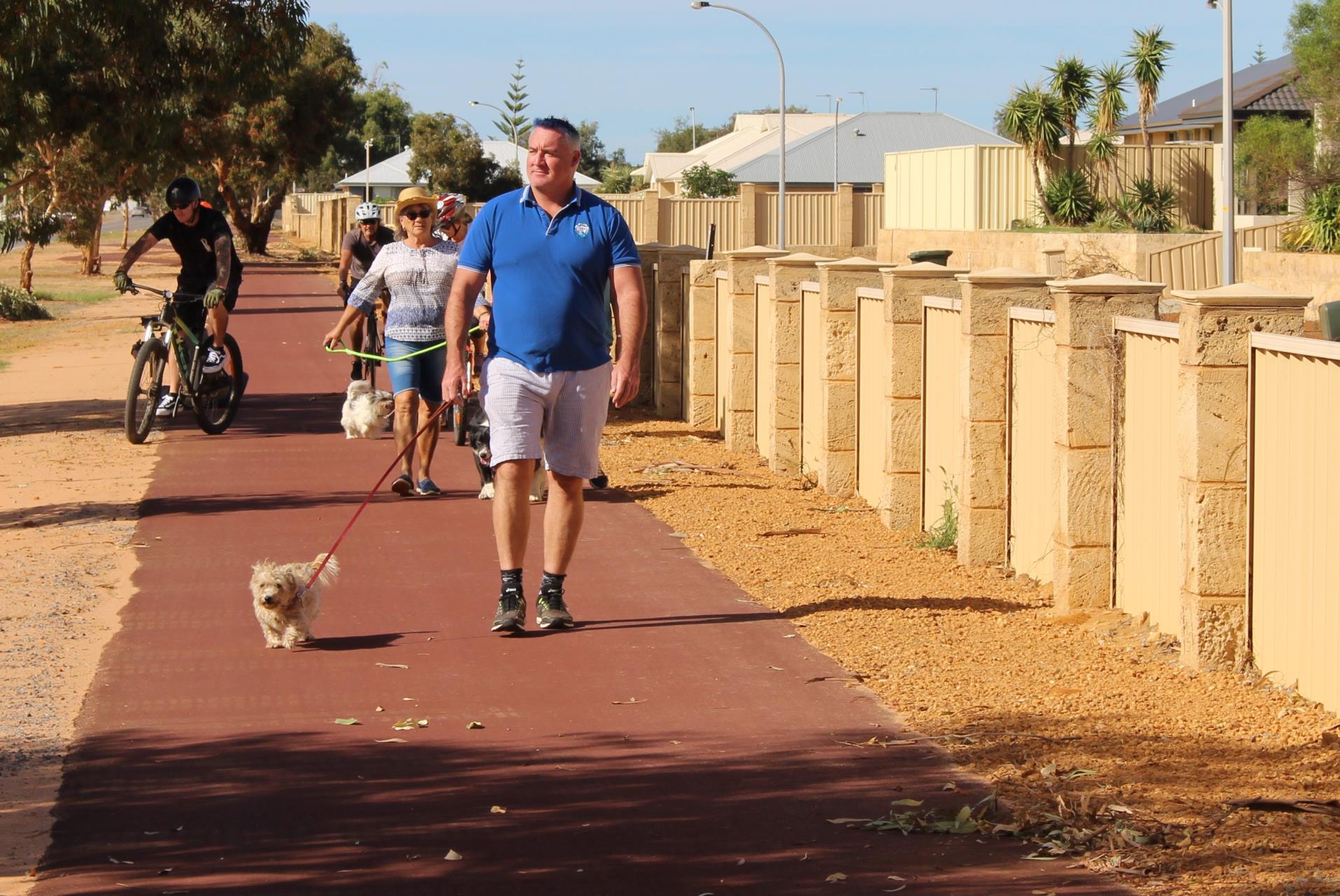 City of Greater Geraldton Mayor Shane Van Styn and his pooch Bella join community members enjoying the recently completed shared path along Chapman Road between Sail Boulevard and Corallina Quays in Sunset Beach. 